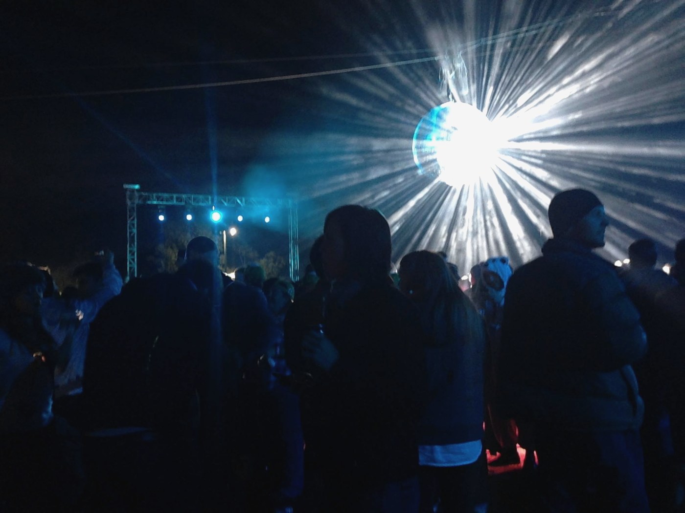 A mirror ball blazing over the crowd at night at the Random Access Memories launch, Wee Waa